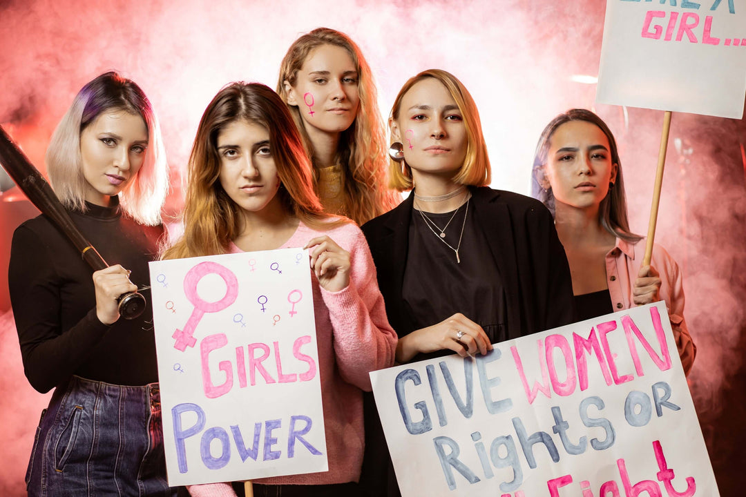 Women holding protest signs for empowerment, inspired by shapewear bodysuits and dresses