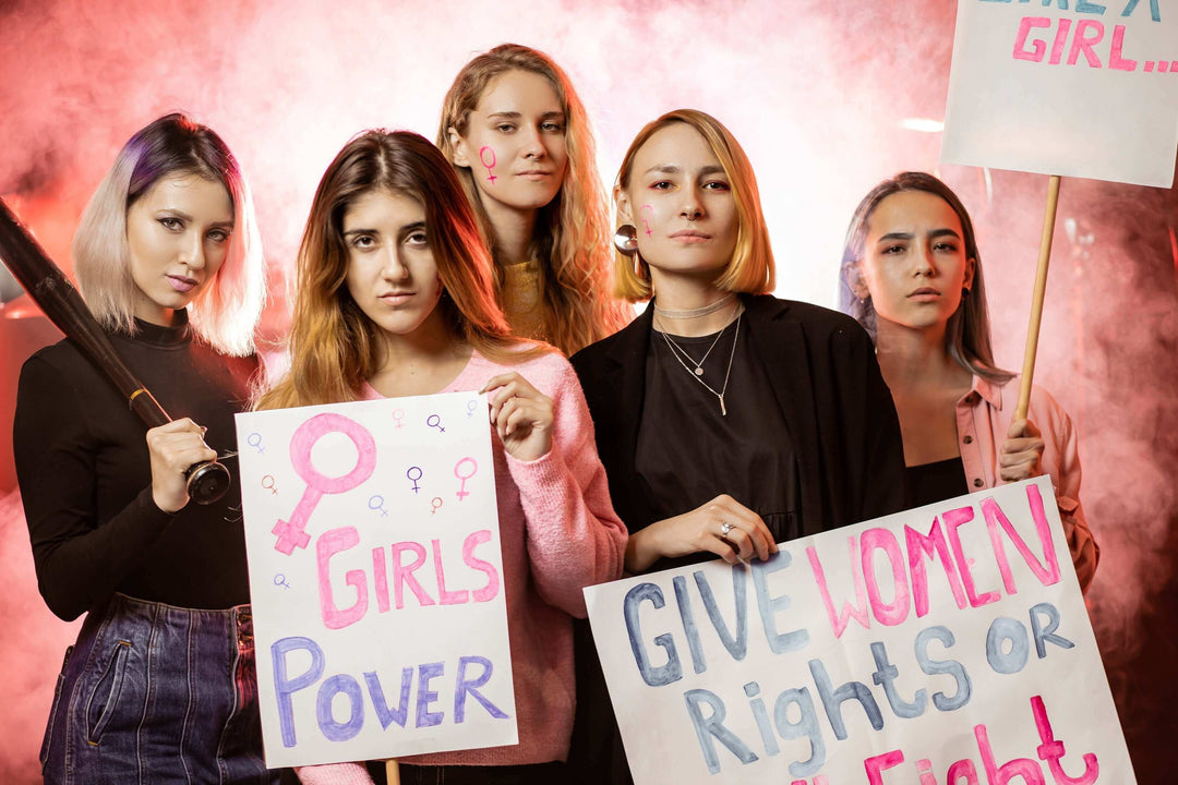 Women holding protest signs for empowerment, inspired by shapewear bodysuits and dresses
