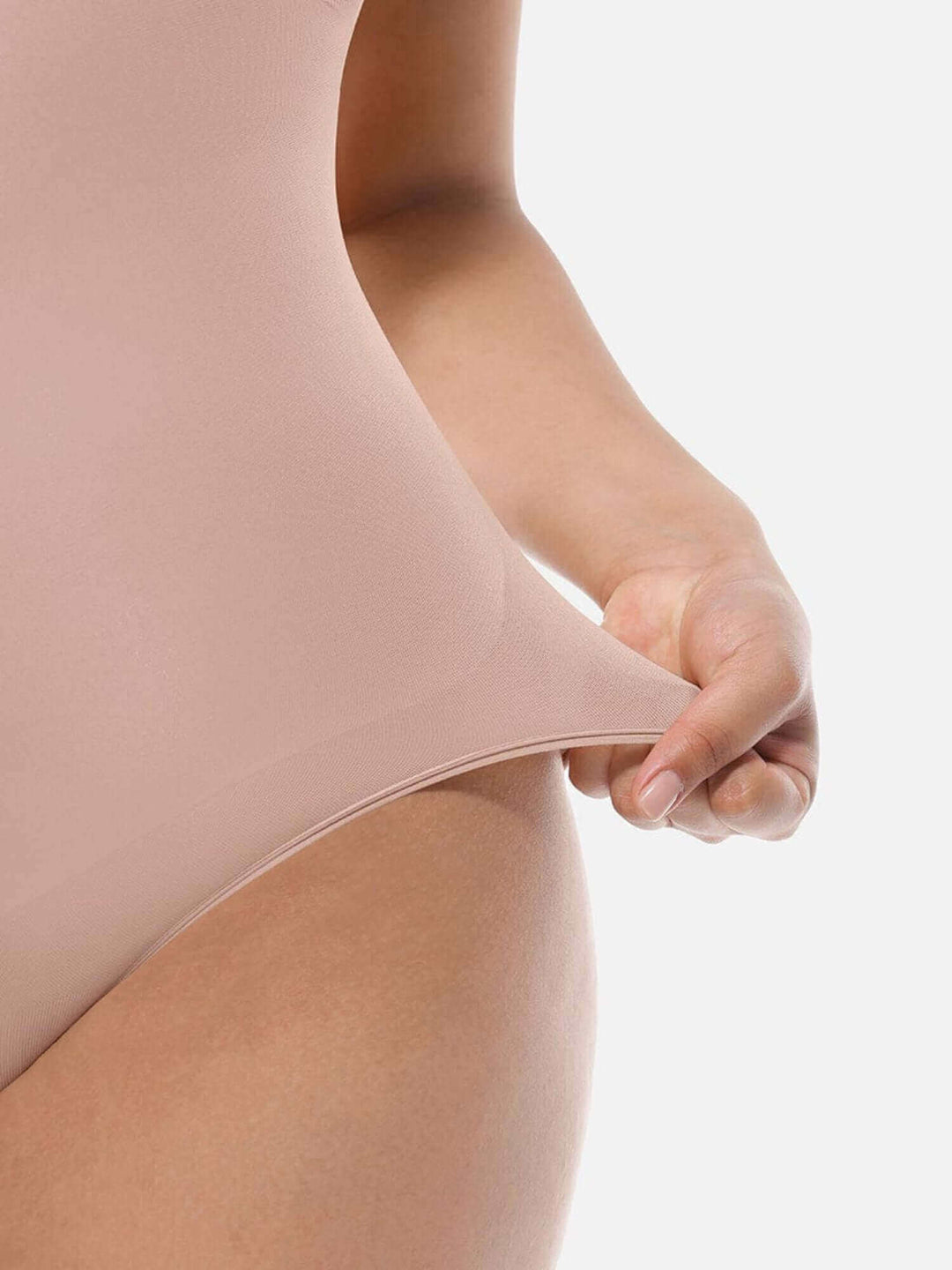 soft sculpting guide showing a woman stretching a nude seamless bodysuit for a comfortable body-hugging fit