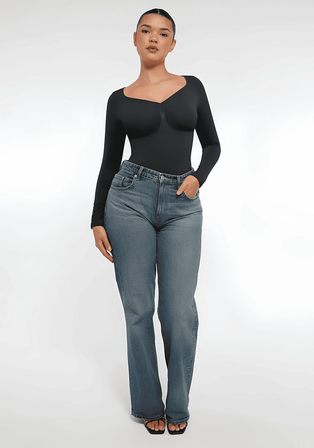 sheer lingerie trends 2026: model in black second-skin top and jeans