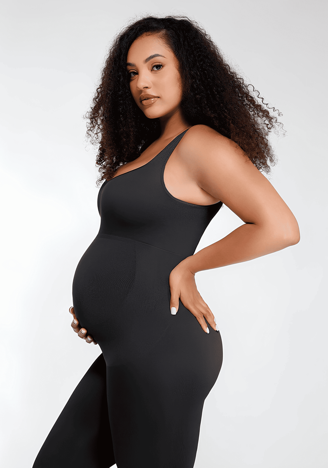 maternity catsuit black sleeveless maternity catsuit for a stylish pregnant woman posing against a white background