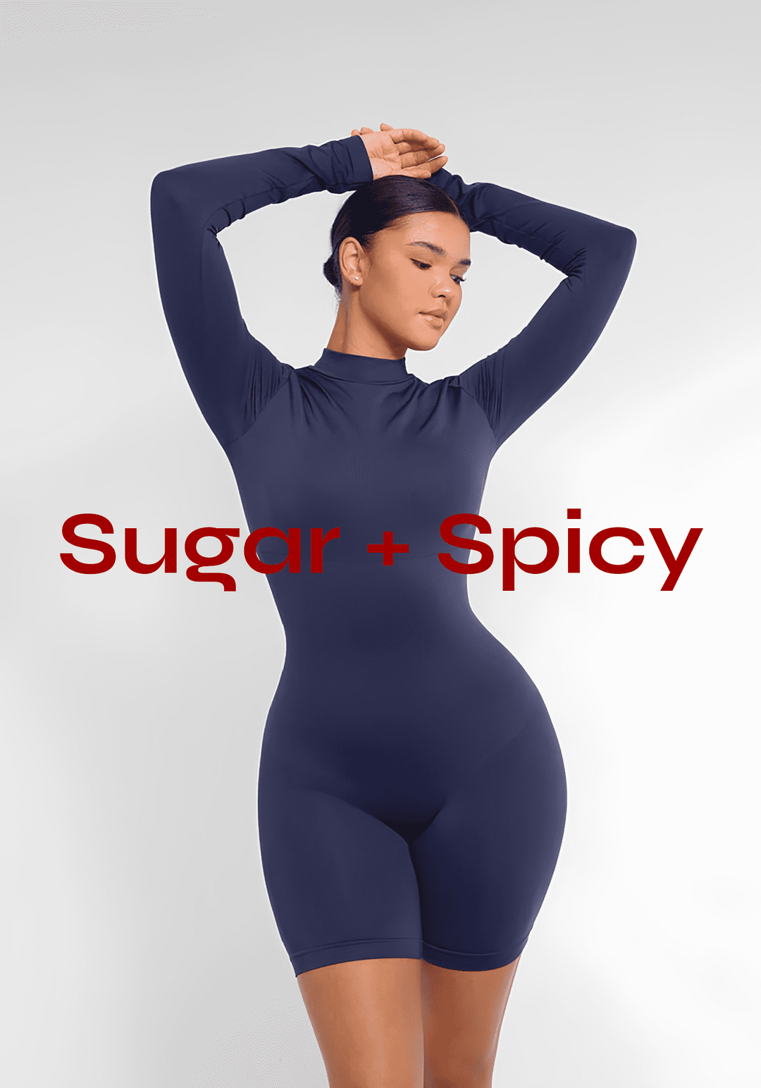 women's jumpsuits and bodysuits model in navy fitted bodysuit posing with arms raised, Sugar + Spicy