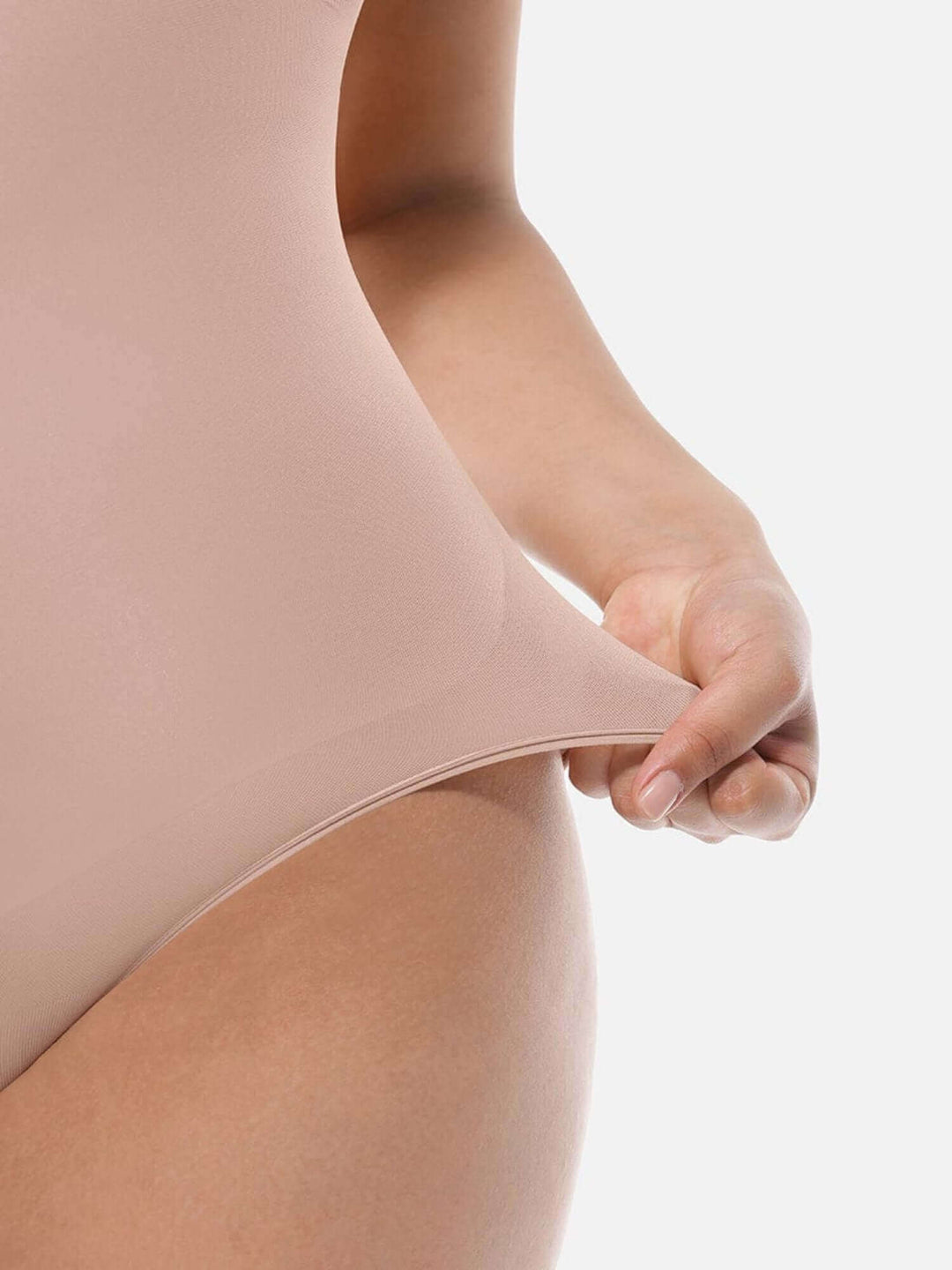 soft sculpting guide showing a woman stretching a nude seamless bodysuit for a comfortable body-hugging fit