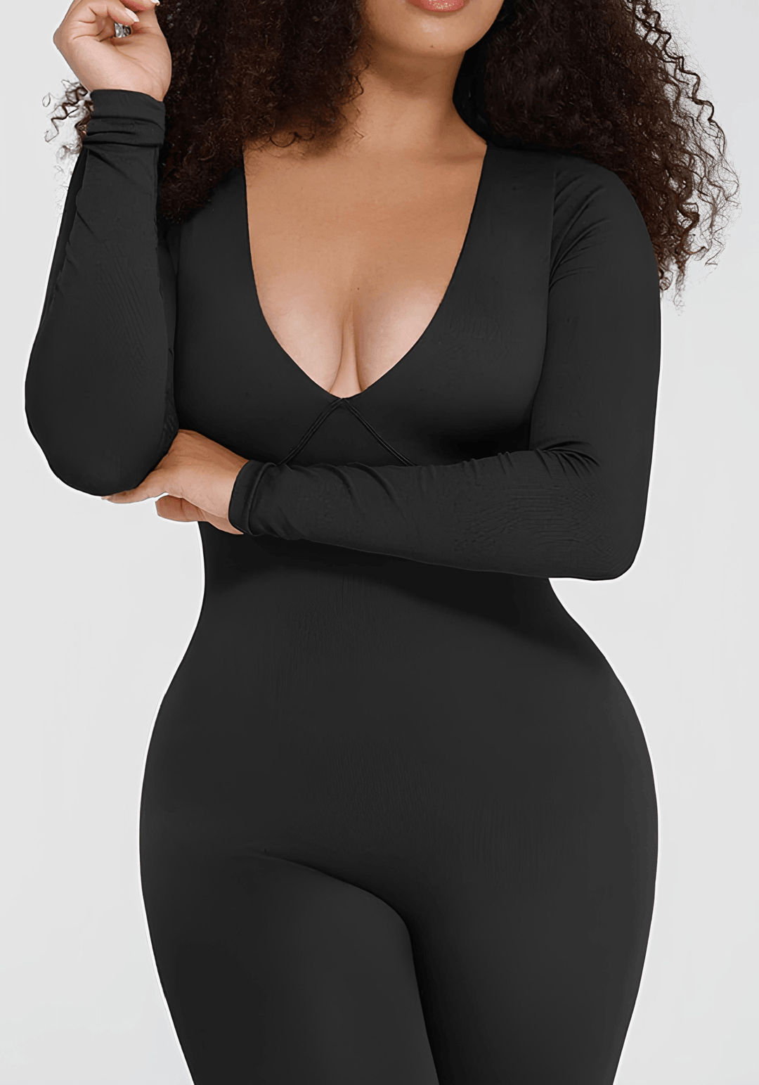 catsuit styling guide featuring a woman in a black fitted catsuit with long sleeves and a plunging neckline