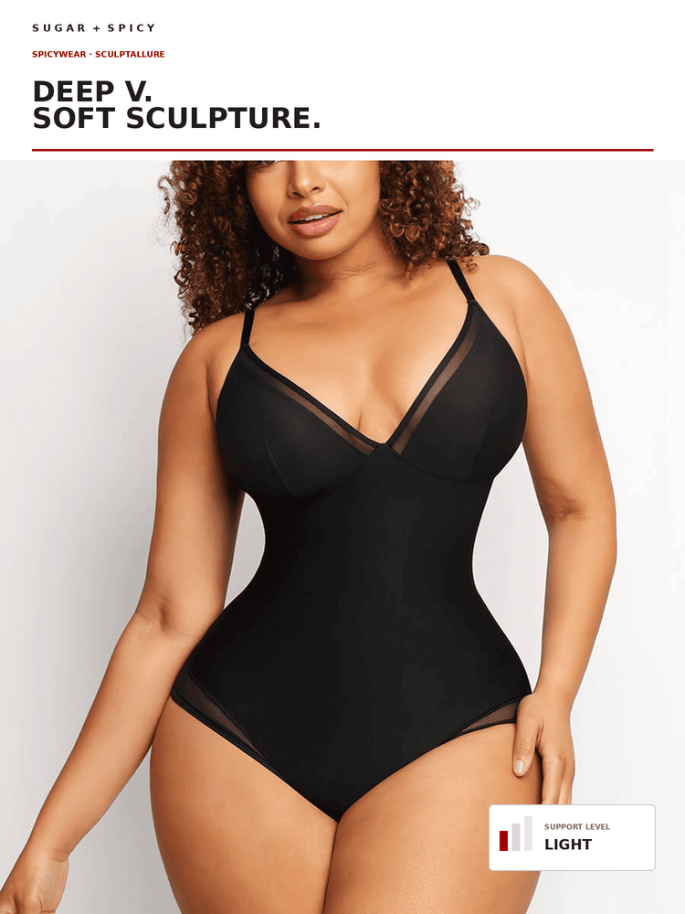 A plus-size model wearing a black sheer underbust bodysuit with a deep V-neckline, shown against a plain white studio background with text overlays.