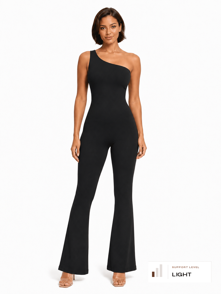 A woman modeling a black one-shoulder flared jumpsuit against a plain white studio background. A small label in the bottom right corner reads 'SUPPORT LEVEL LIGHT'.