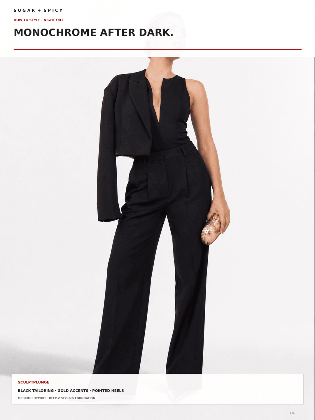 A model wears a black monochrome jumpsuit with a structured one-shoulder blazer-style sleeve, a deep V-neckline, and wide-leg trousers, styled with a small metallic clutch against a light gray background.