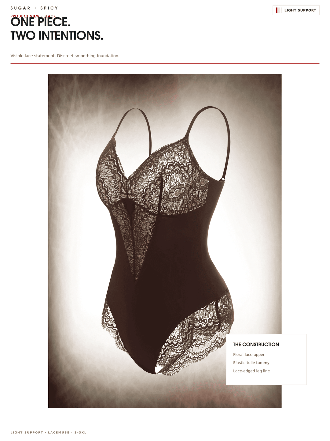 A lingerie bodysuit shown on a mannequin against a dramatic studio background. The garment is black with intricate sheer lace cups and lace trim at the waist and hips.