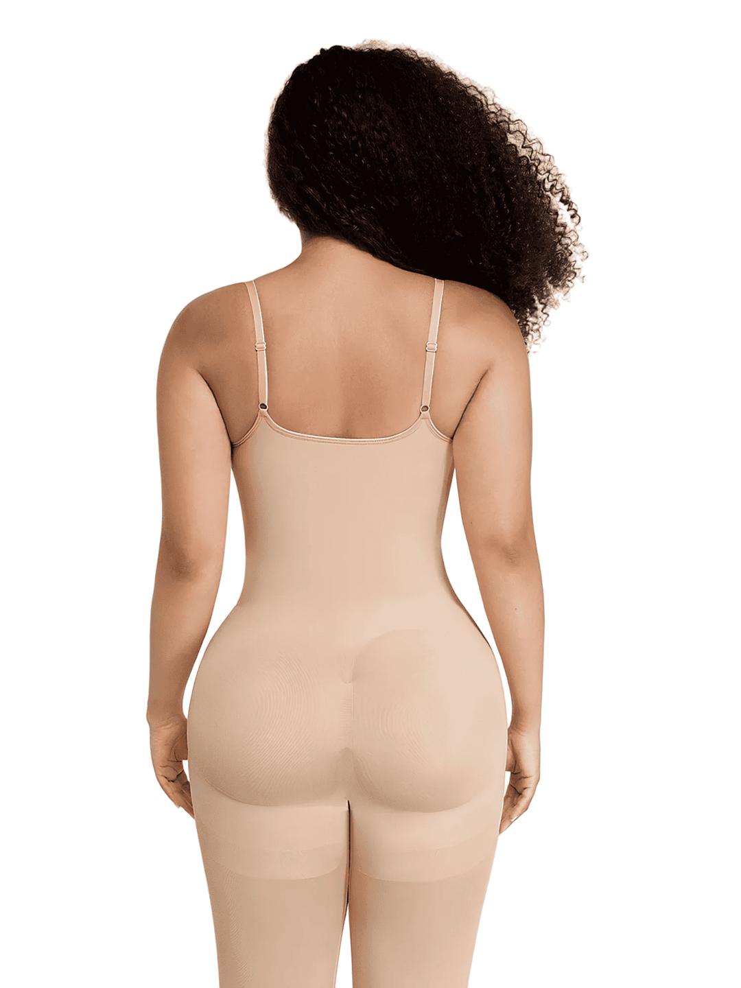 Rear view of a model wearing a light beige shapewear bodysuit with thin shoulder straps and integrated hip pads, set against a plain white background.