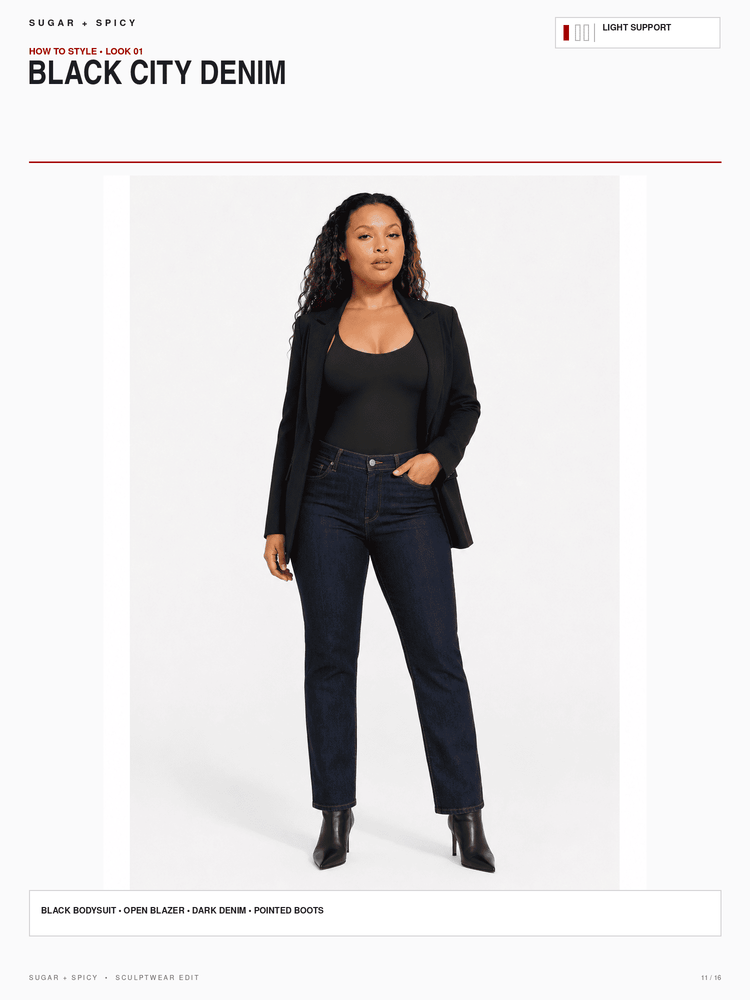 A model stands against a light gray studio background wearing a black blazer, black top, dark blue denim jeans, and black ankle boots. The image includes text headers reading 'SUGAR + SPICY', 'BLACK CITY DENIM', and 'LIGHT SUPPORT' with a small color swatch box at the top right.