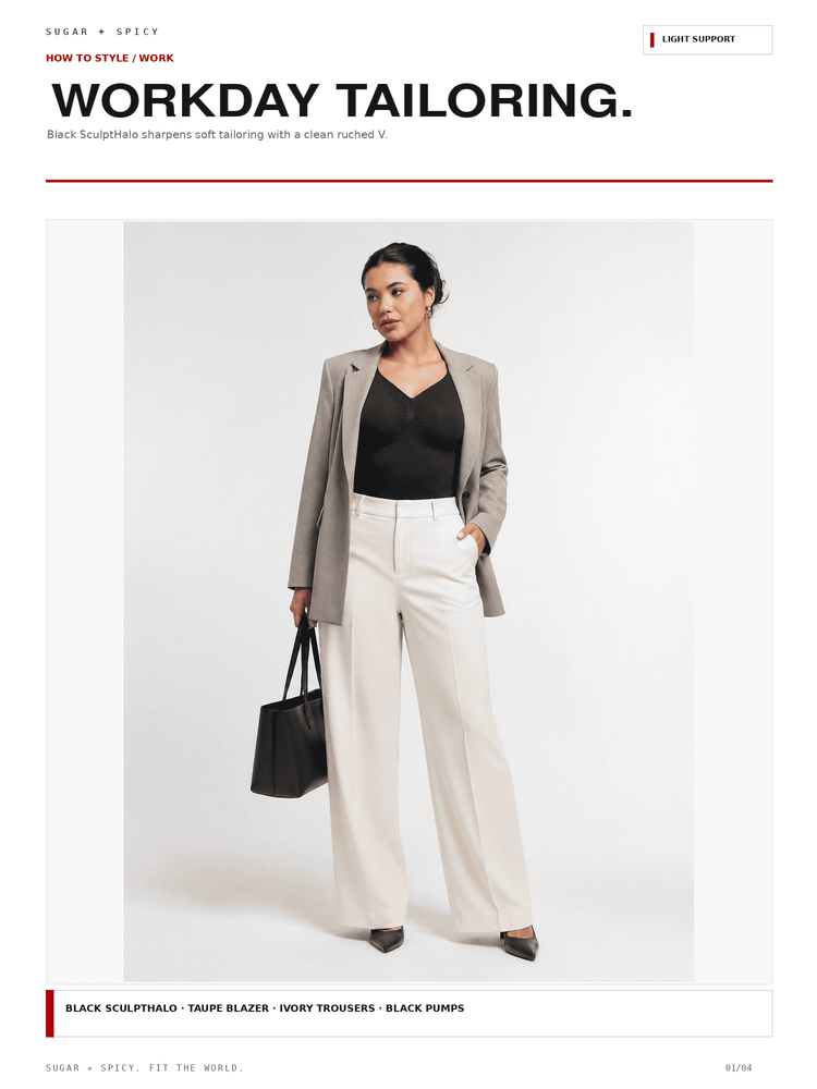 A fashion editorial-style photo shows a woman standing against a light gray studio background wearing a light taupe blazer, black top, off-white trousers, and black heels, while holding a black handbag. Large text at the top reads 'WORKDAY TAILORING.