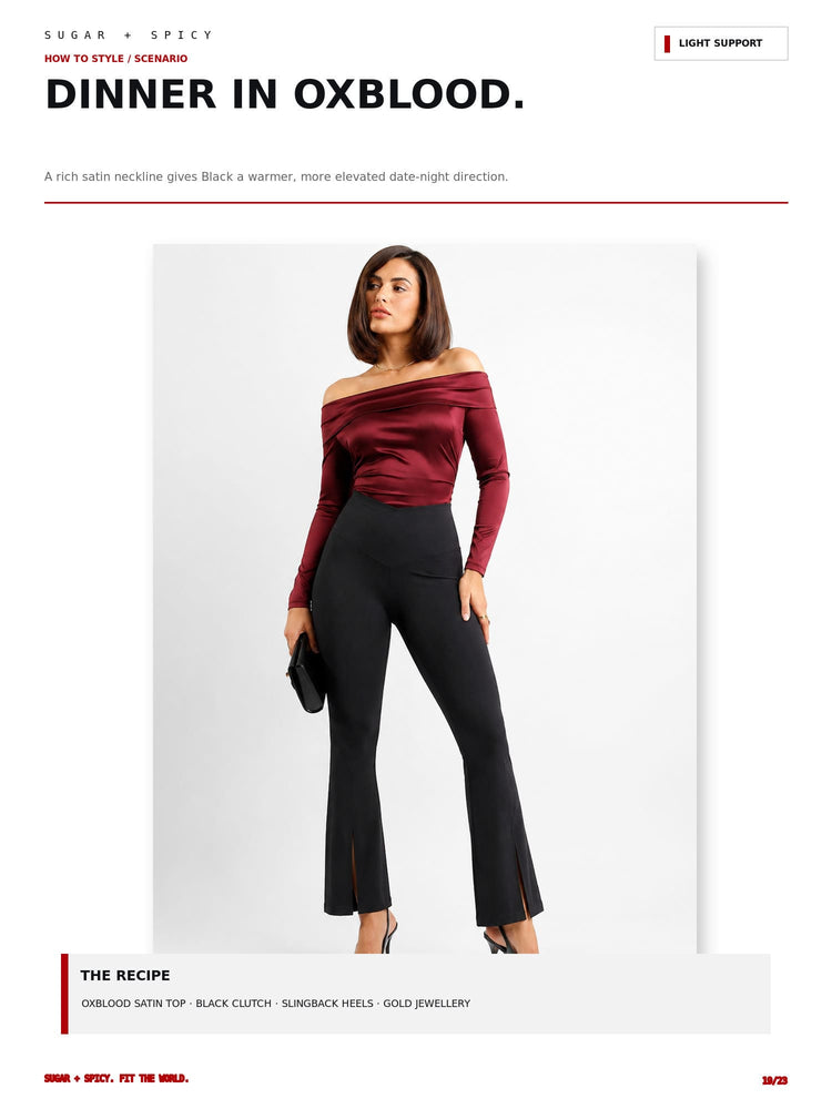 A fashion editorial page showing a model wearing a burgundy off-the-shoulder satin long-sleeve top and black flared pants with side slits, under the heading 'DINNER IN OXBLOOD.' with styling notes.