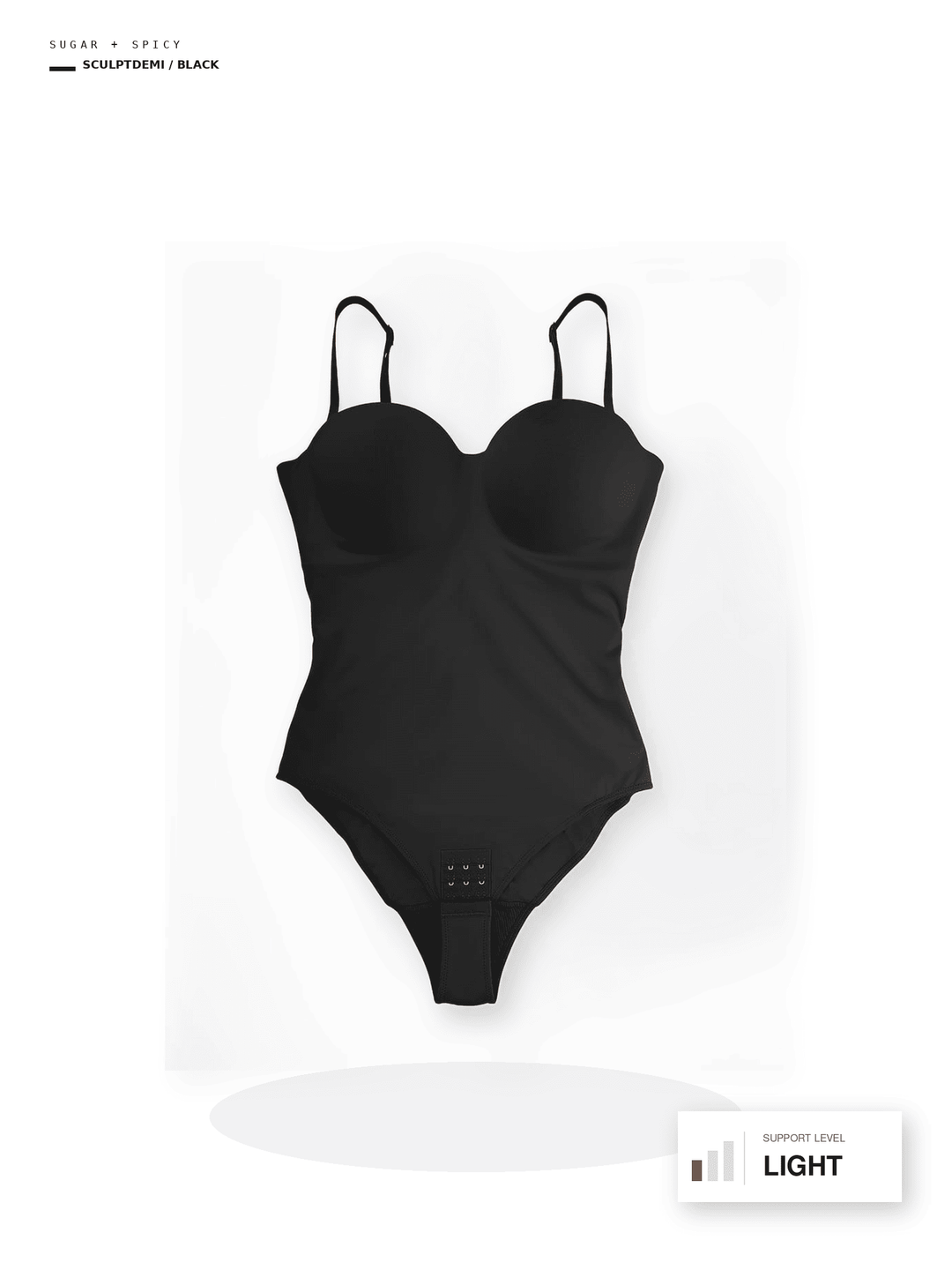 A black one-piece bodysuit with a sweetheart neckline and thin shoulder straps, shown against a white background with a soft shadow. Small text labels in the corners indicate &