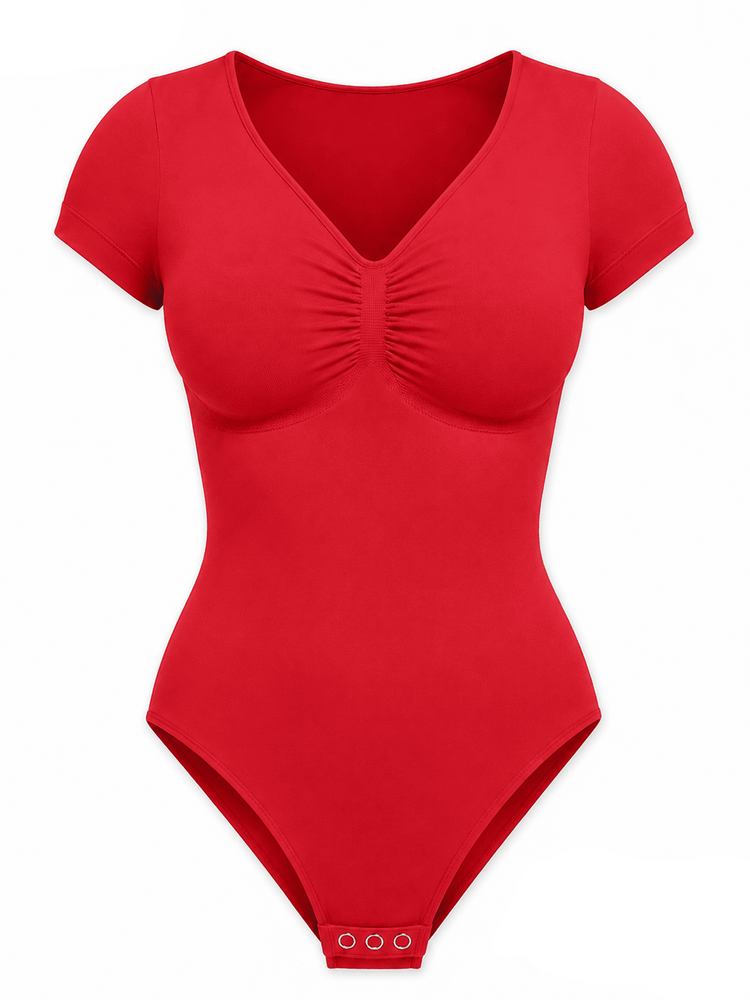 A bright red short-sleeve bodysuit with a ruched V-neckline, displayed on a clean white background with informational text overlays.
