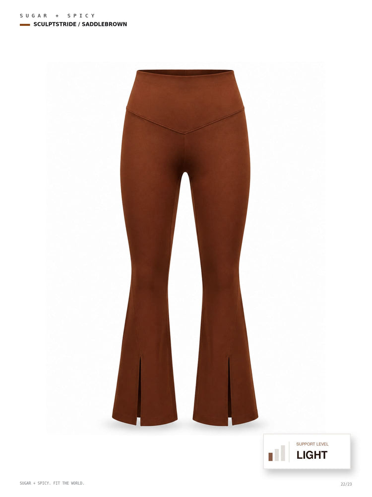 A pair of high-waisted, flared brown pants with front slits at the hem, shown on a clean white background with text labels indicating the shade as 'SUGAR + SPICY' and 'SCULPTSTRODE / SADLEBROWN'.