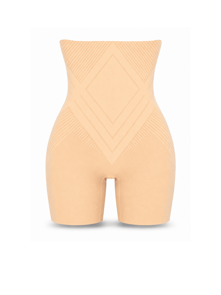 A high-waisted compression shapewear brief in a light peach-beige shade, shown from the front on a white background. The garment features a wide waistband and textured geometric patterns on the torso and thighs.