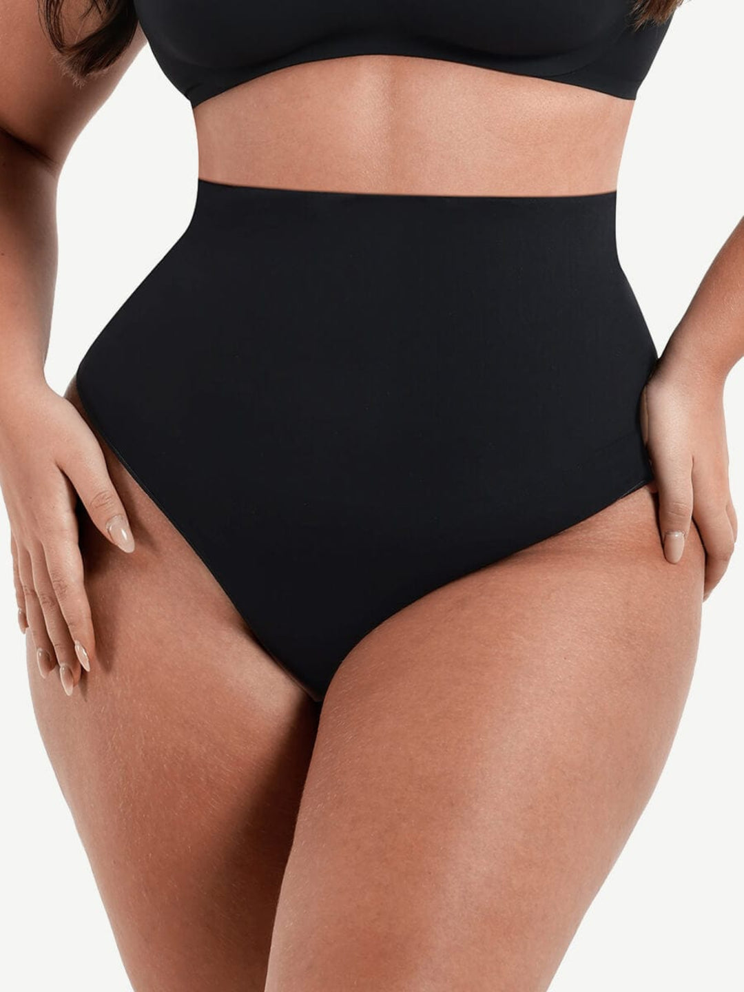 Black high-waisted bikini bottom on a neutral background