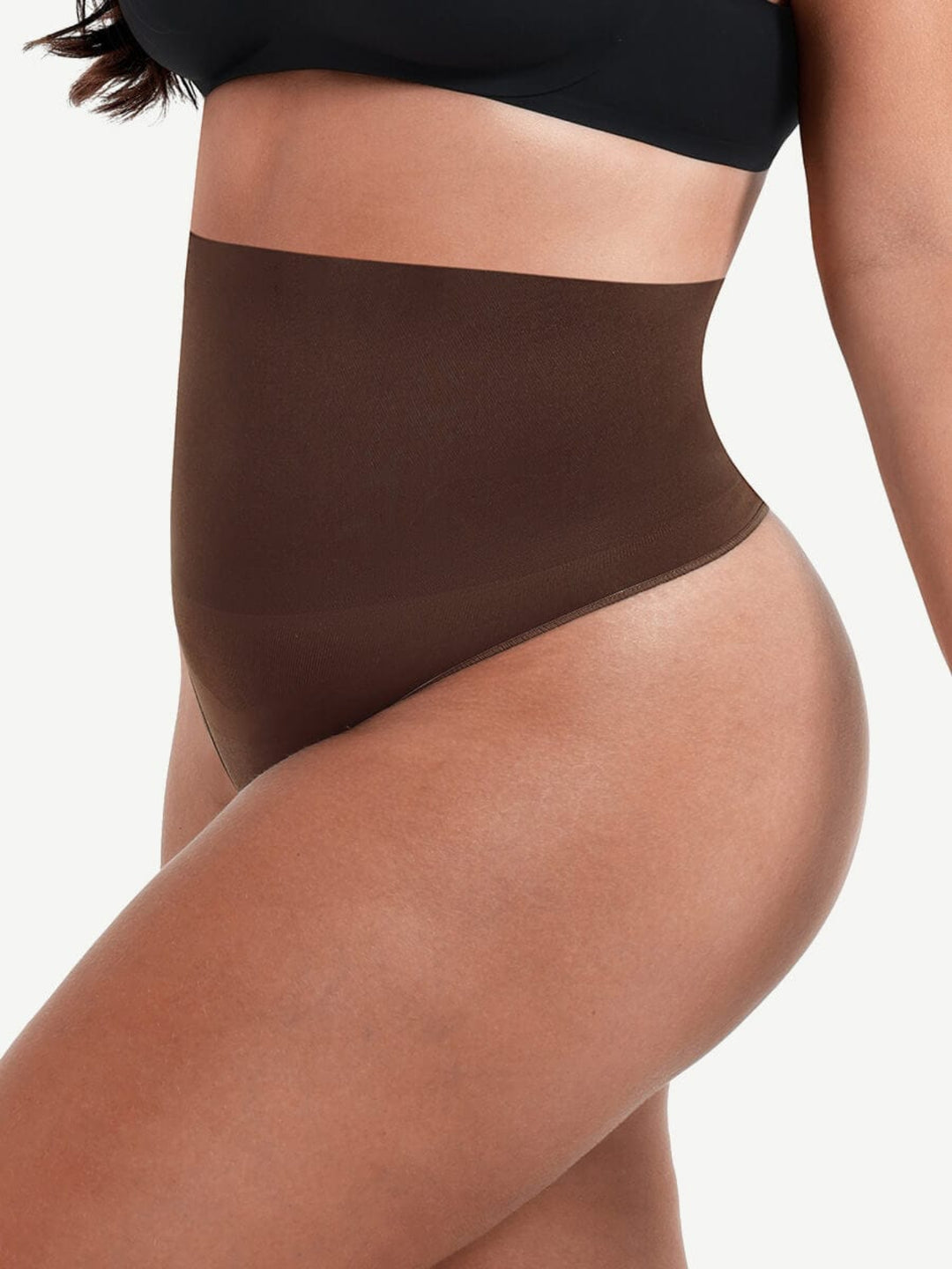 Brown high-waisted underwear worn by a person on a white background