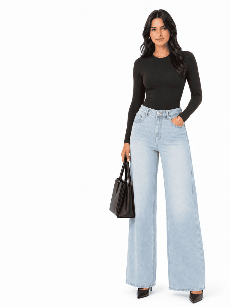 Model wearing a BodySculpt seamless long sleeve bodysuit with wide-leg jeans and a black handbag, showcasing a stylish outfit.