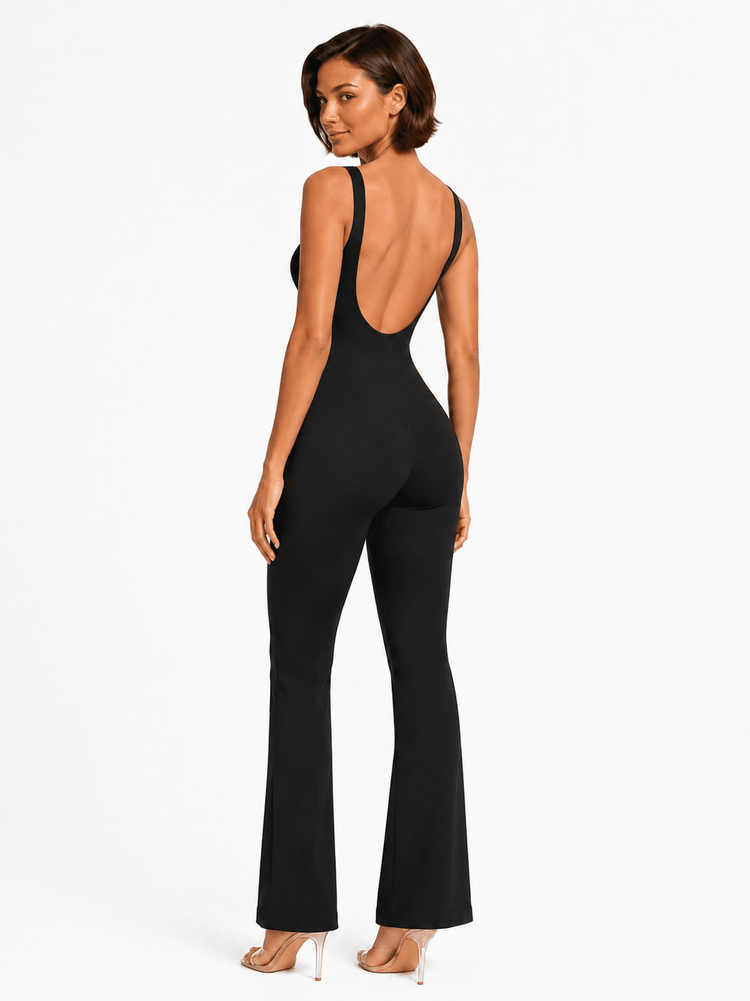 A woman modeling a black sleeveless jumpsuit with a wide open back and flared legs, shown from the back against a plain white studio background.