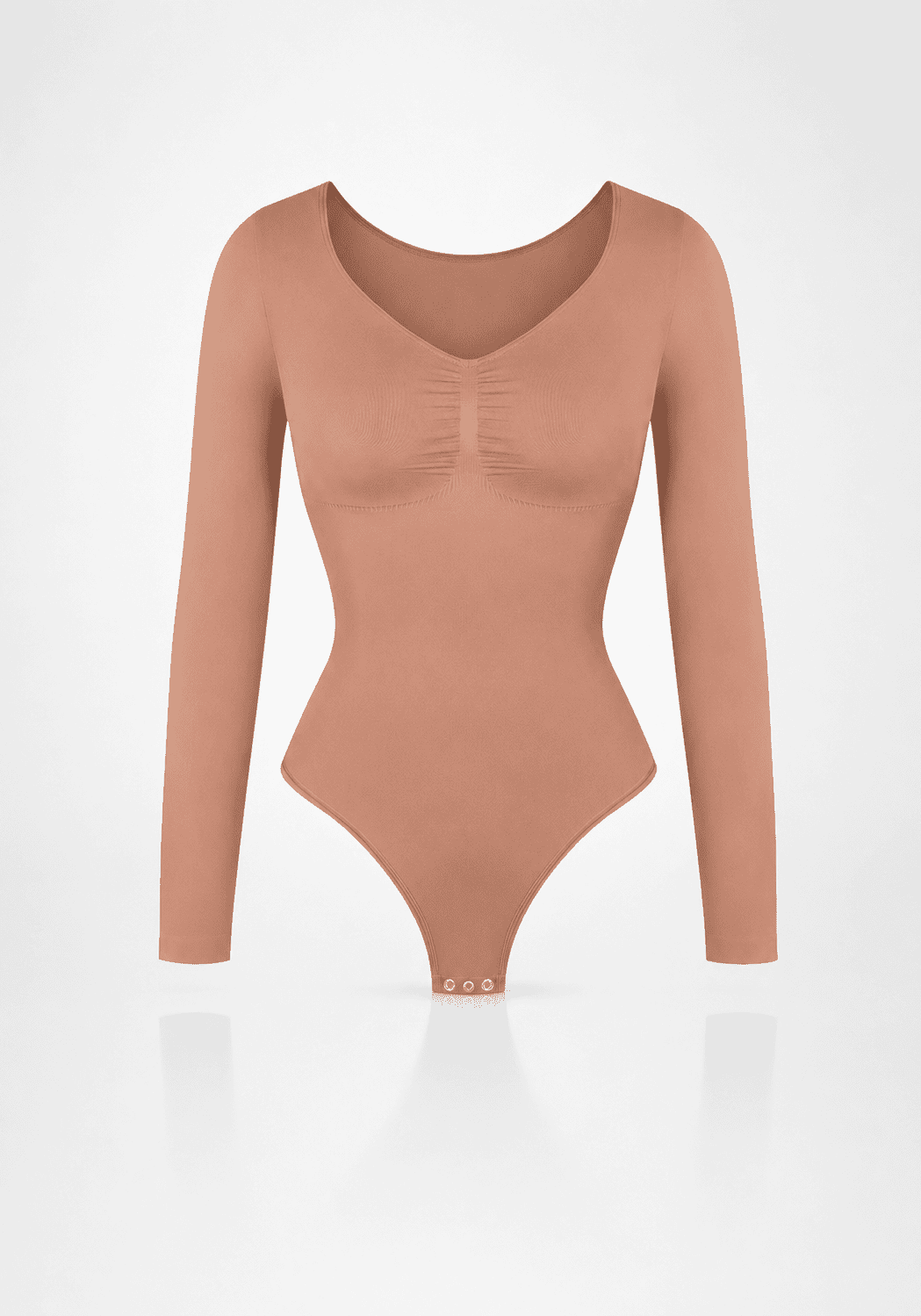 Sculpting long sleeve bodysuit in soft peach color with seamless design and light compression features.