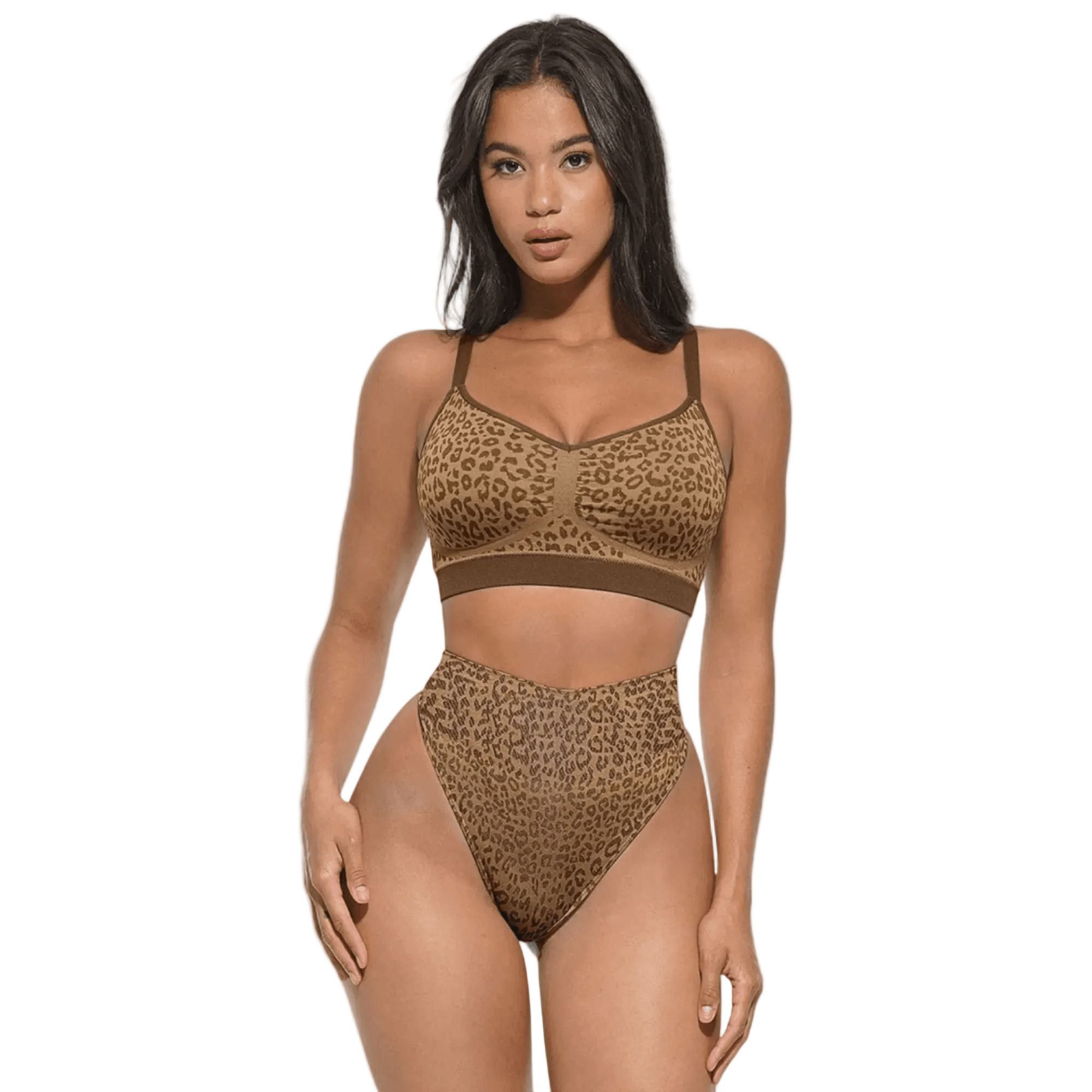 Woman modeling leopard print sports bra and high-waisted underwear set on white background