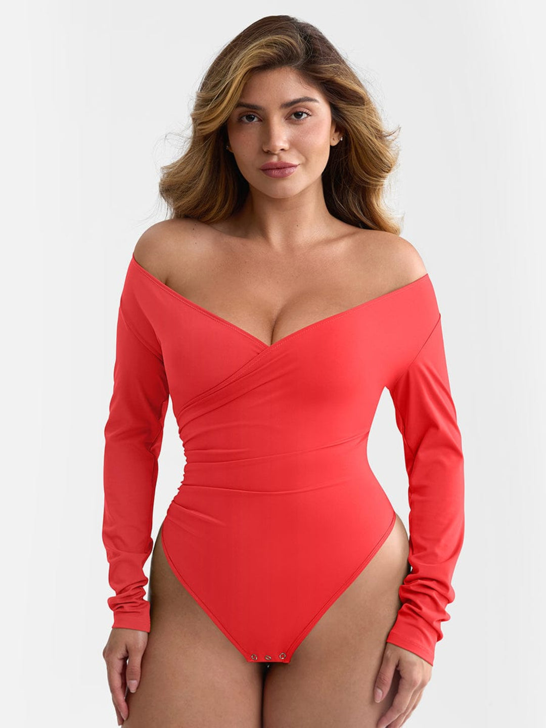 Woman wearing a red off-shoulder swimsuit on a white background