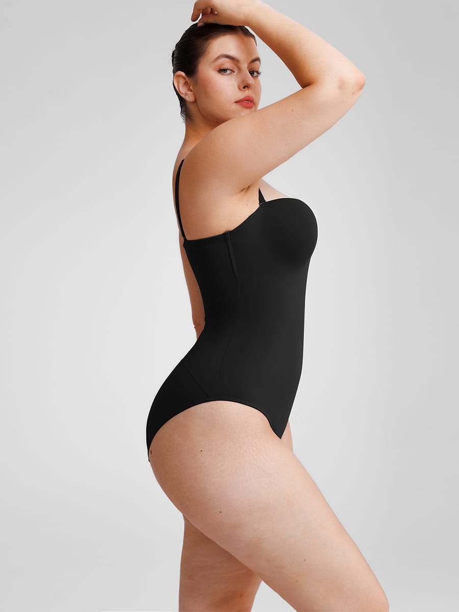 Woman wearing a black swimsuit against a plain background