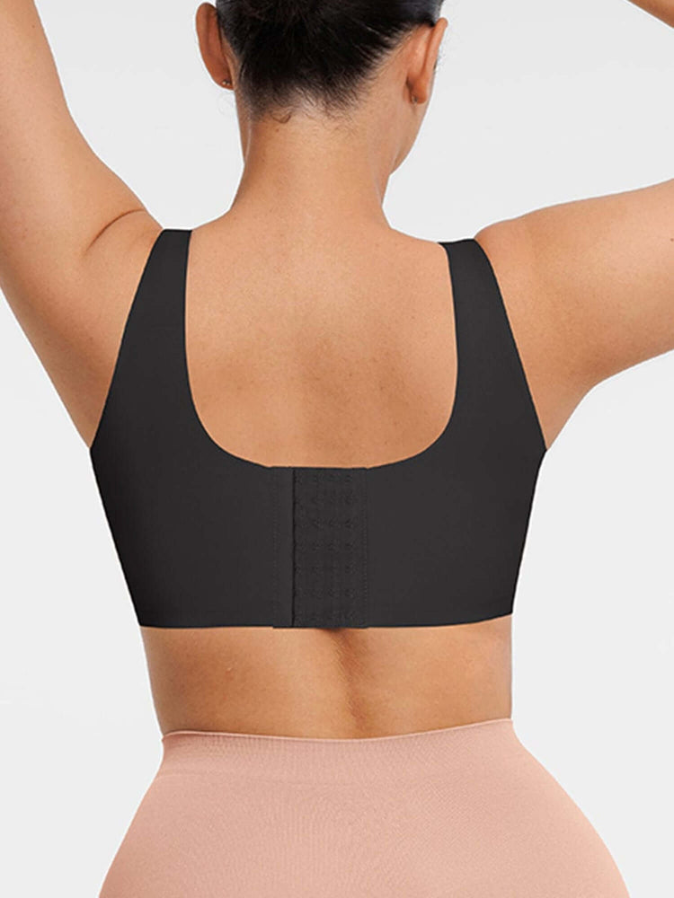 Black sports bra worn by a person on a light gray background