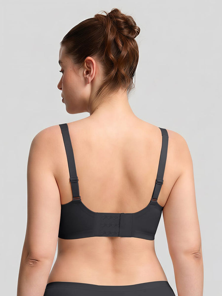 Woman wearing a black bra against a gray background