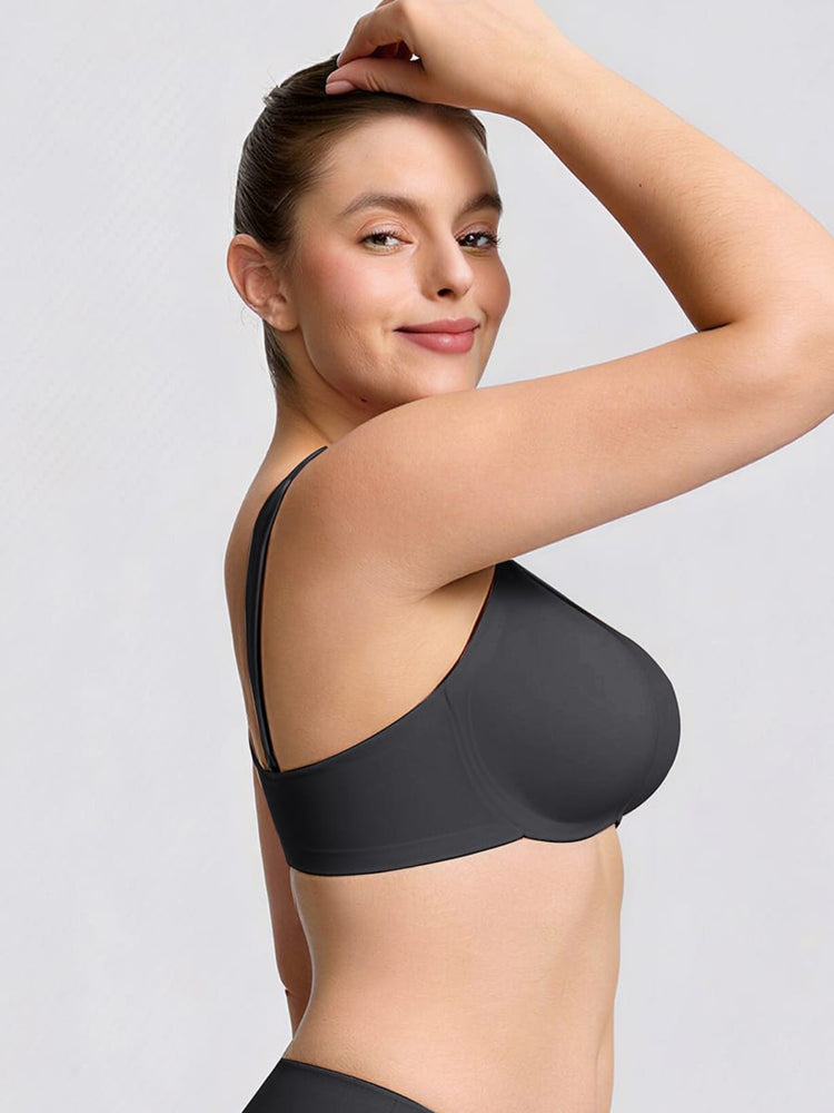 Woman wearing a black bra against a light gray background