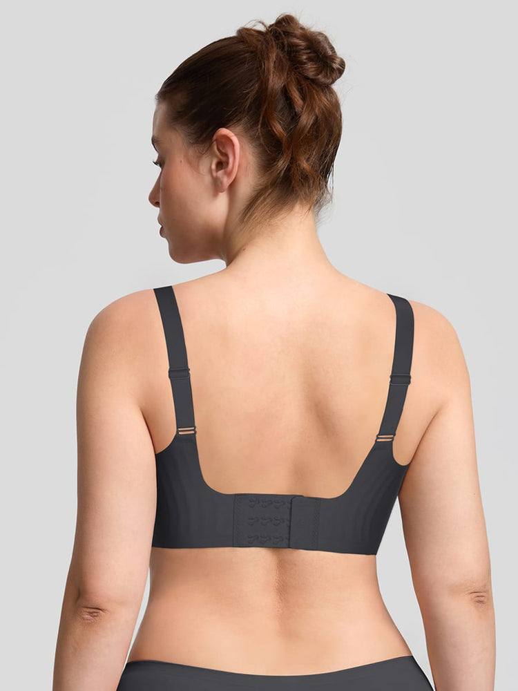 Woman wearing a black sports bra on a gray background