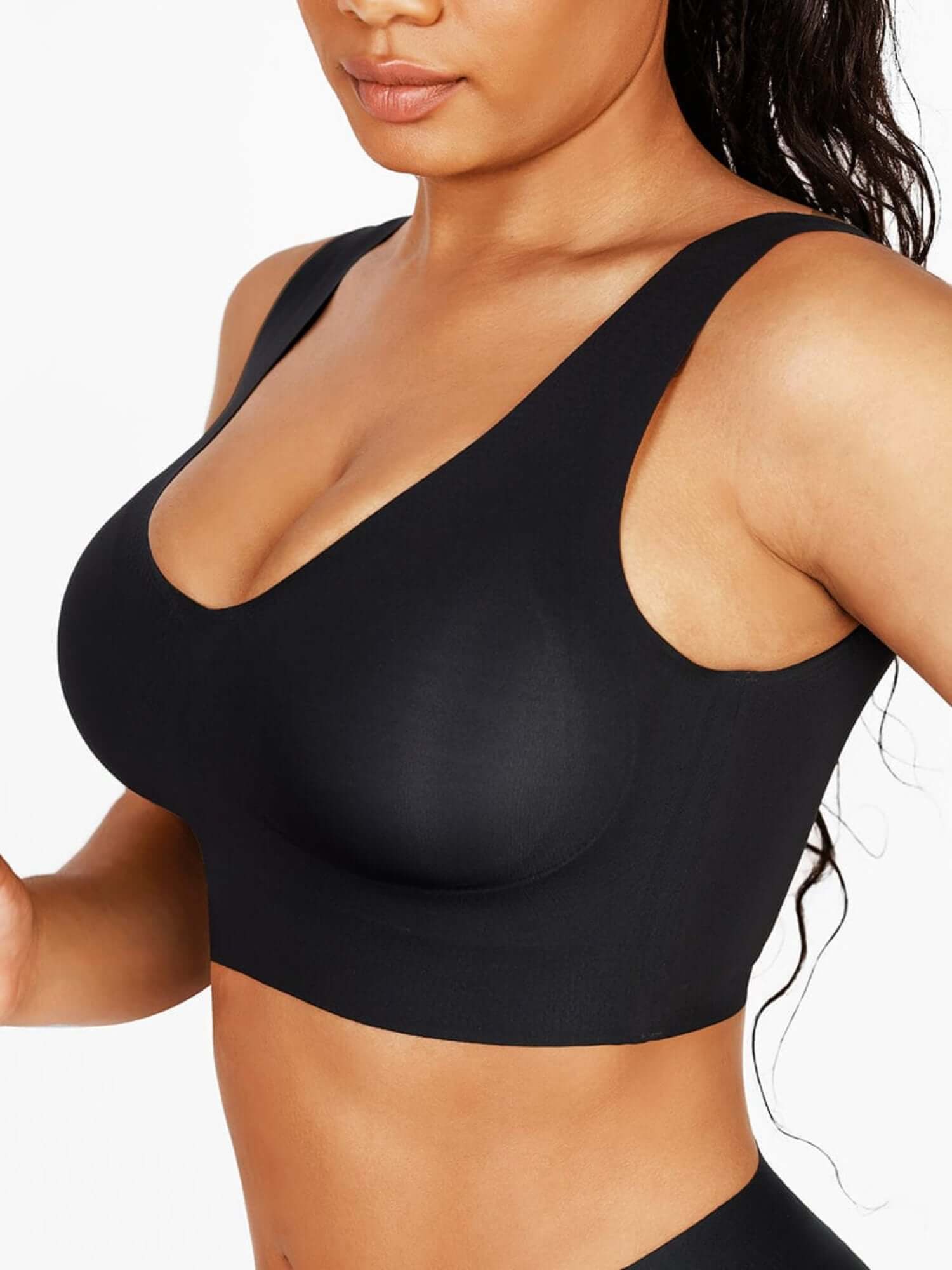 Black sports bra worn by a person on a white background