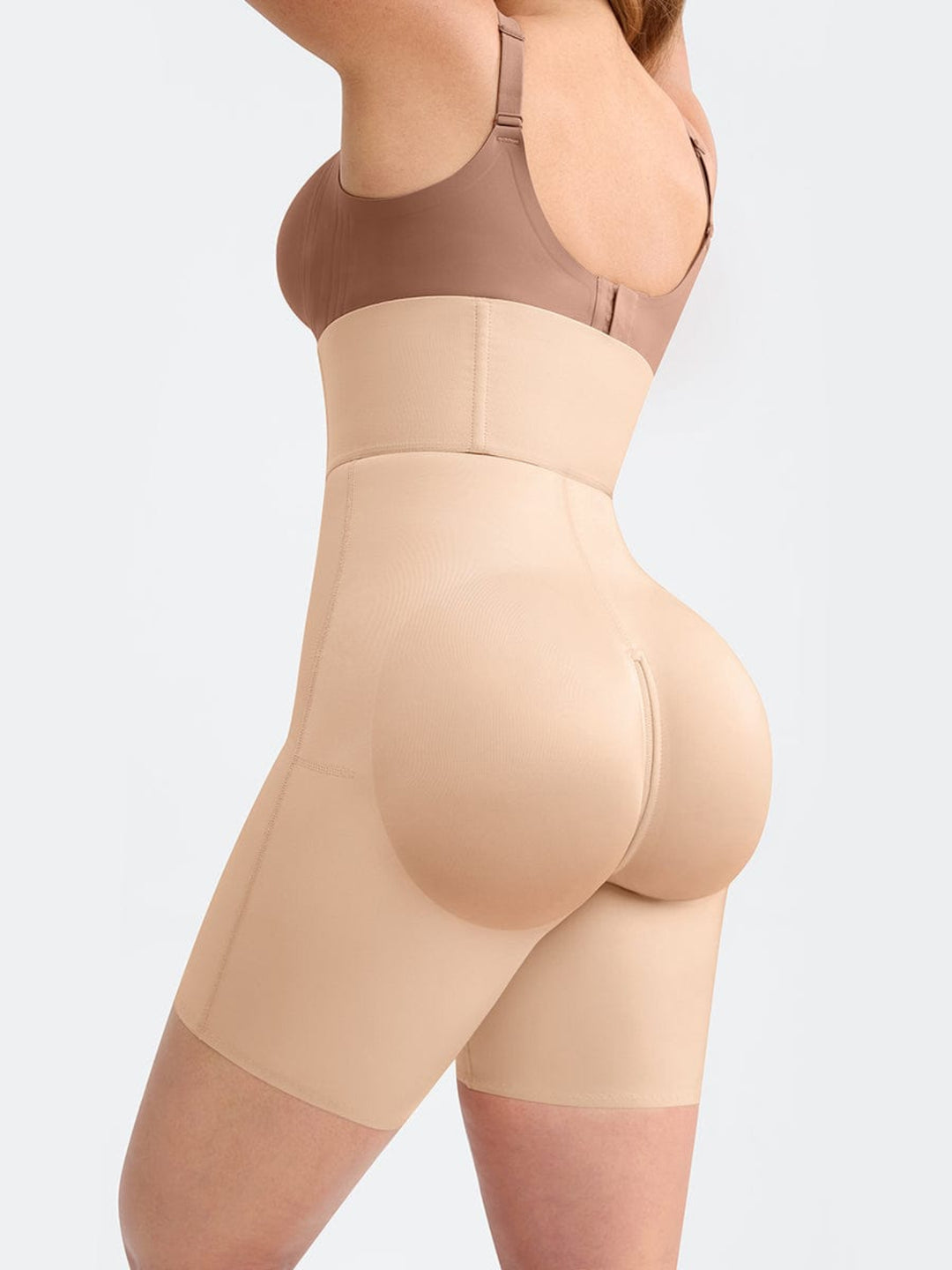 Beige shapewear worn by a person on a light gray background