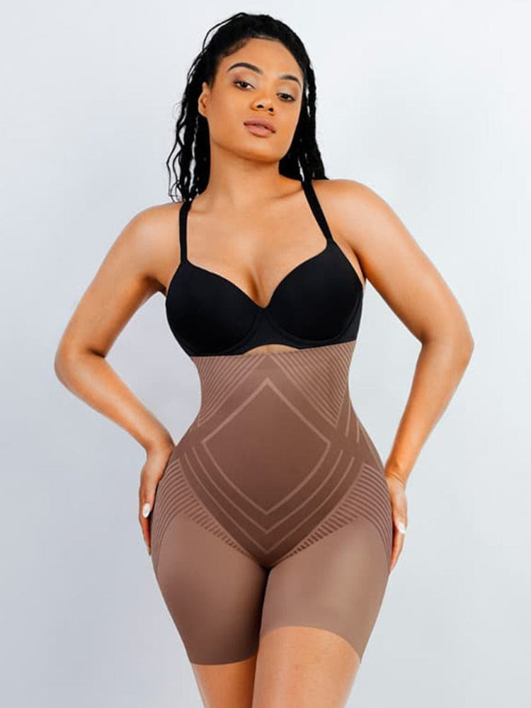 Woman wearing a black bra and brown shapewear against a light gray background
