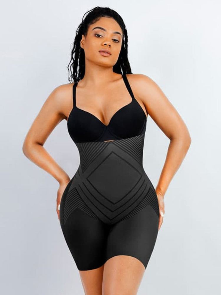 Woman wearing a black swimsuit with geometric design on a light gray background