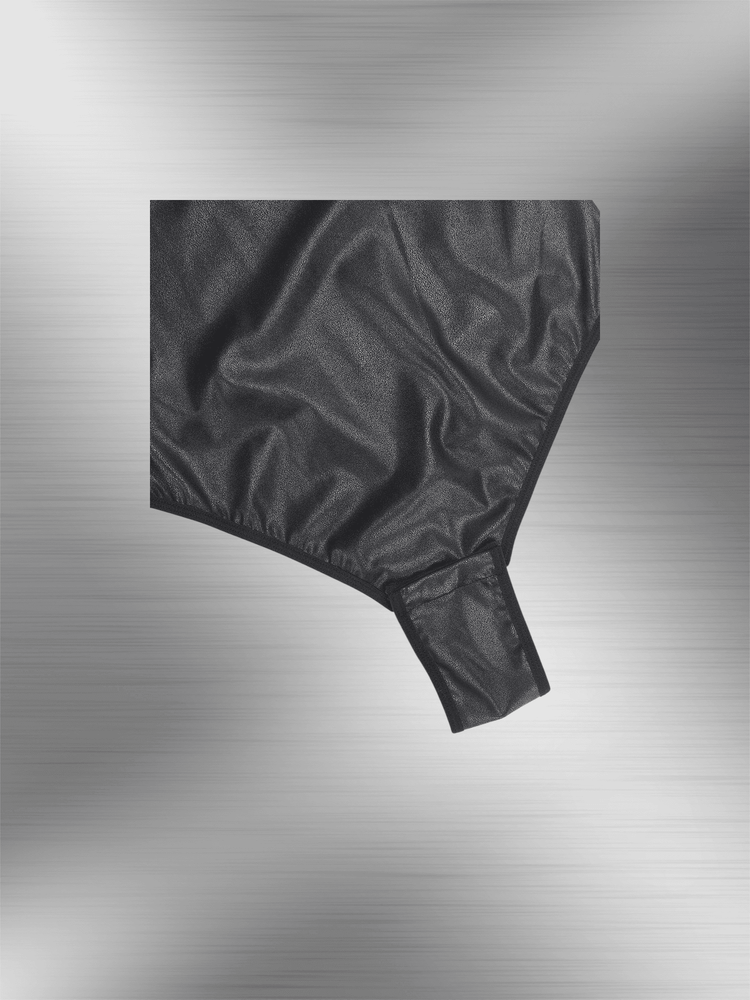 faux leather bodysuit close-up showing glossy black textured fabric and fitted bottom detail