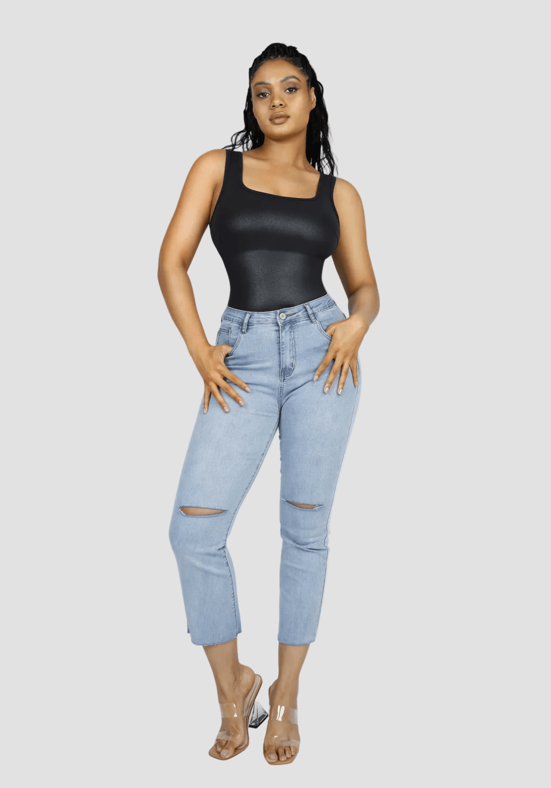 faux leather bodysuit with square neckline styled with light blue jeans and clear heels, polished glossy finish for day-to-night wear