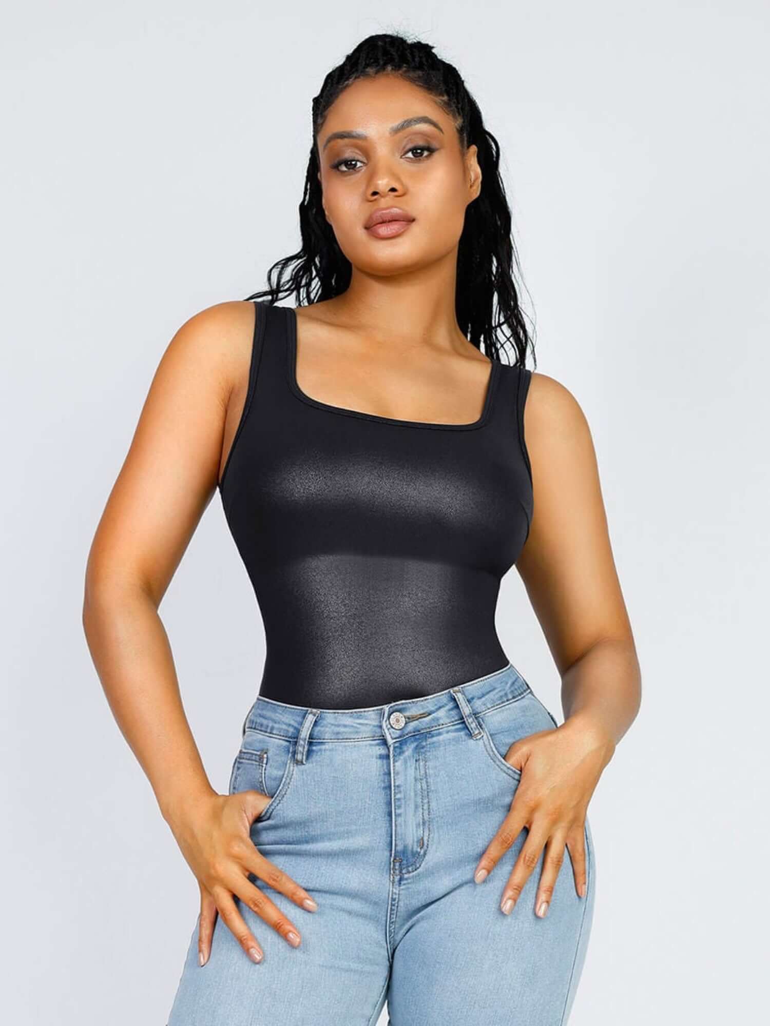 Faux leather bodysuit with square neckline and figure-hugging fit, styled with light blue jeans for a sleek look
