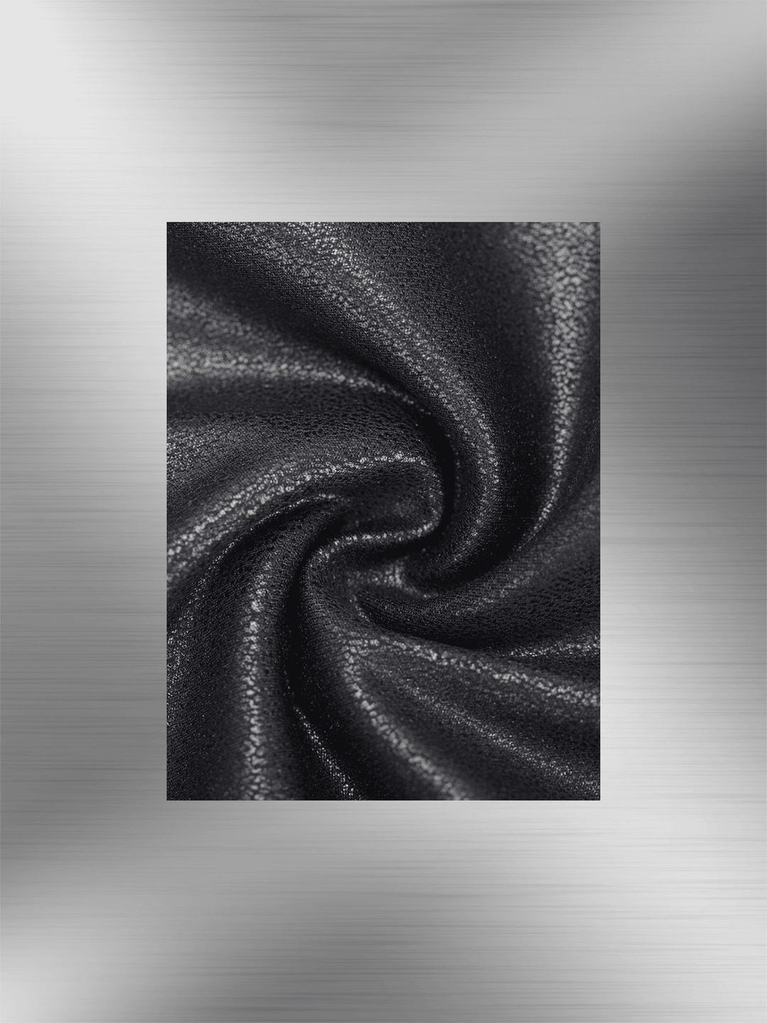 Faux leather bodysuit fabric close-up with glossy black texture and soft stretch finish
