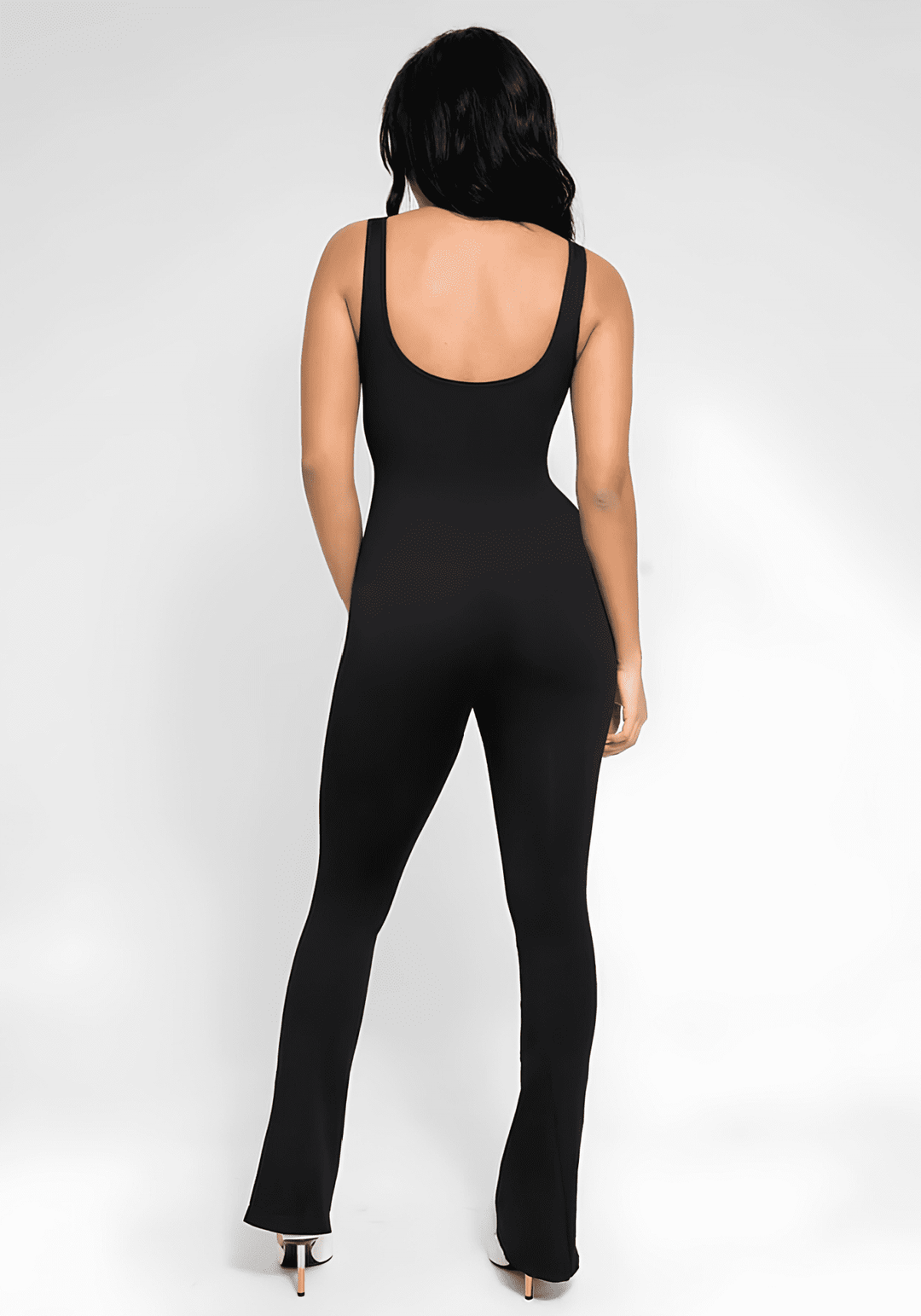 flared open back jumpsuit with square neck and flared legs, black body-skimming one-piece from back view