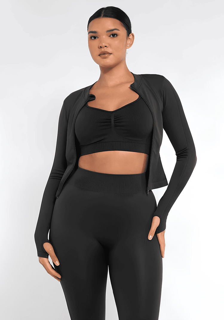 Black full zip running top with thumb holes, seamless fit, and flattering waist shaping for women