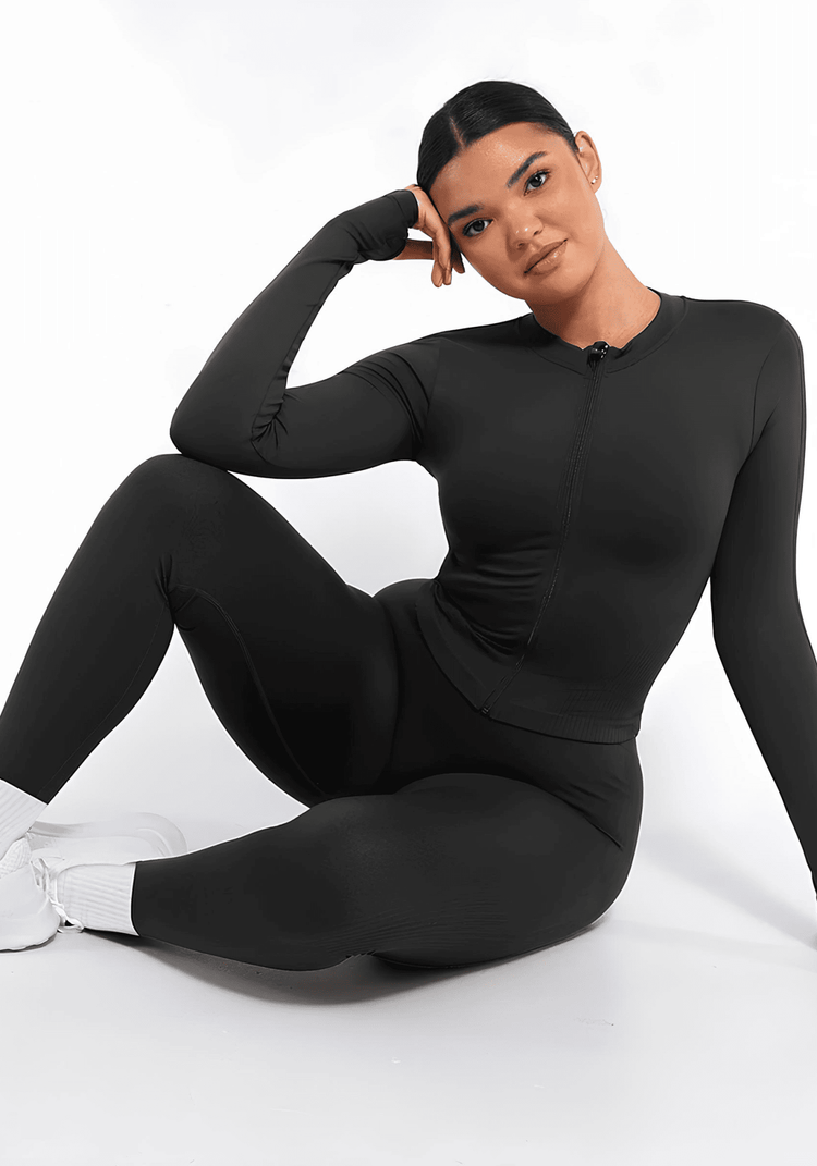 full zip running top with thumb hole technology, sleek black long sleeve athletic top for women