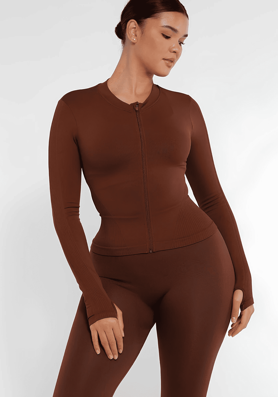 full zip running top with thumb holes, seamless fit and light compression for a flattering athletic silhouette