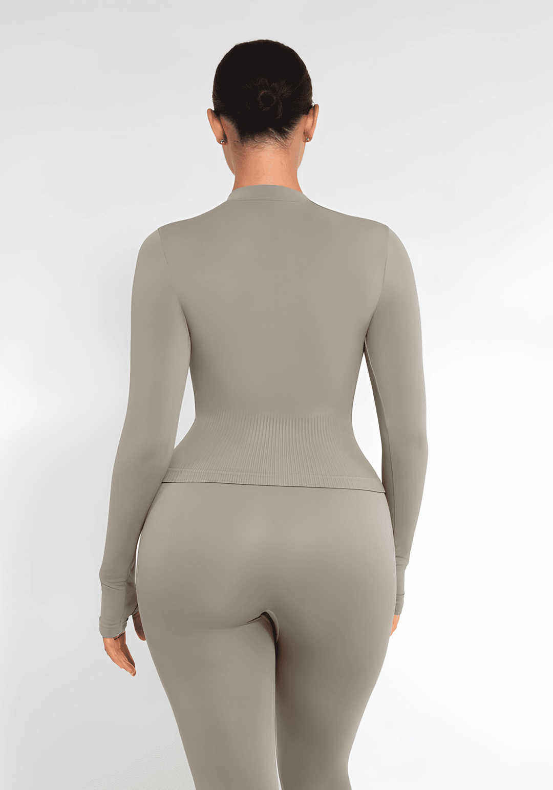 full zip running top with thumb holes, seamless fit, long sleeves, and flattering back view