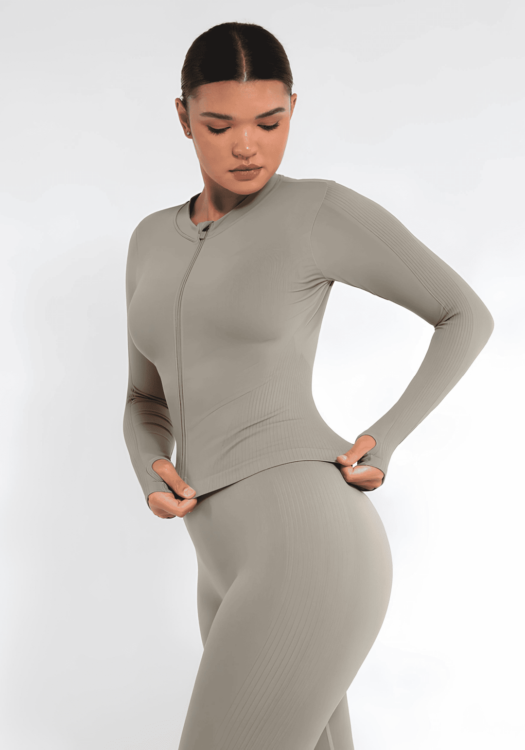 full zip running top with thumb hole technology, seamless fit, light compression, and flattering silhouette in beige