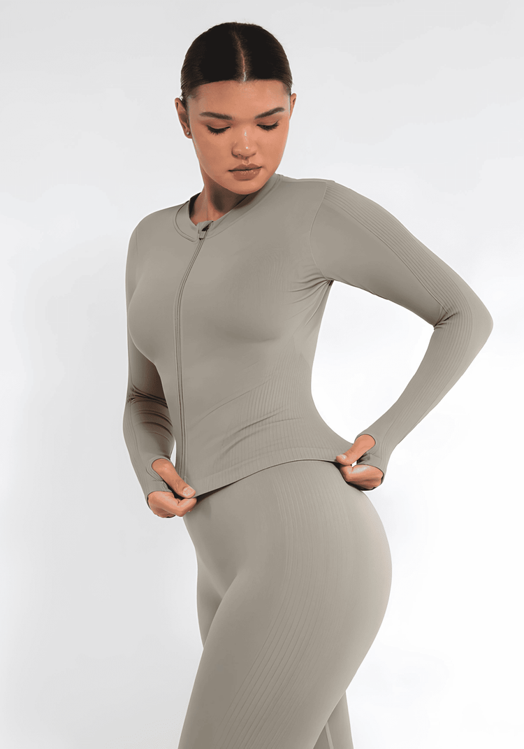 full zip running top with thumb hole technology, seamless fit, light compression, and flattering silhouette in beige