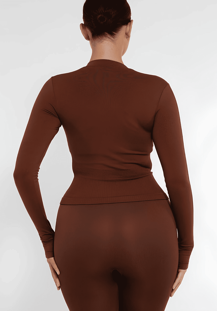 full zip running top with thumb holes, seamless fit, long sleeves, and flattering waist shaping
