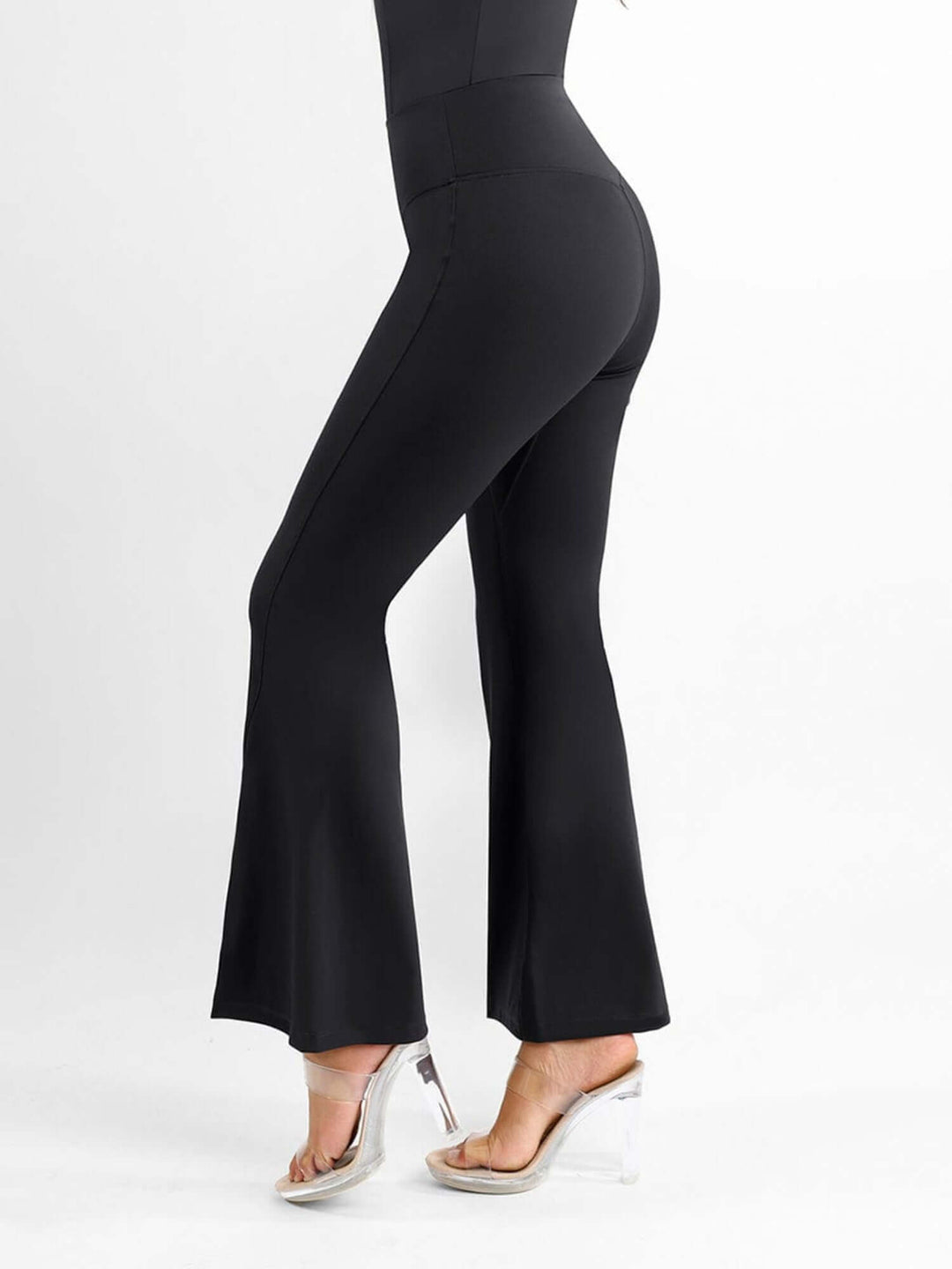 High-waisted front slit leggings in black with flared leg design and body-shaping fit for a sleek workout look
