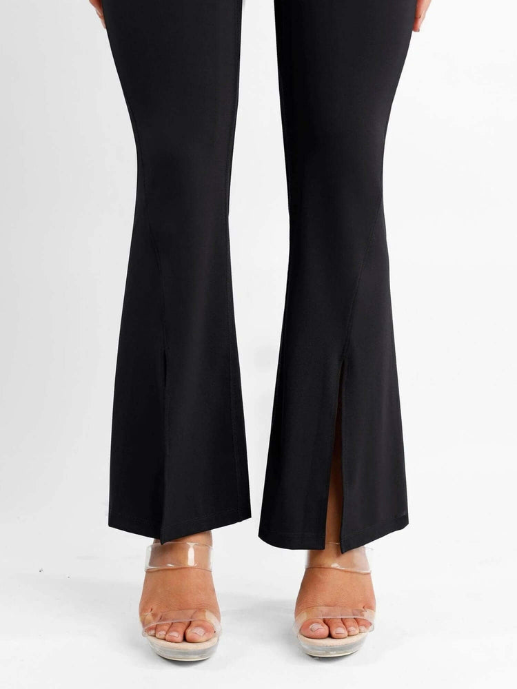 High-waisted front slit leggings in black with flared legs and stylish front slit design for a slim, elongated look